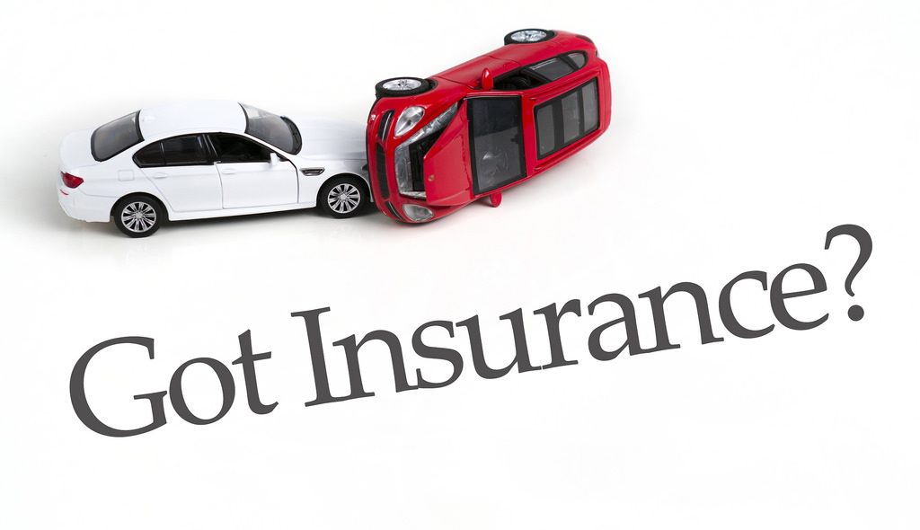 car accident with model cars with words "Got Insurance?"