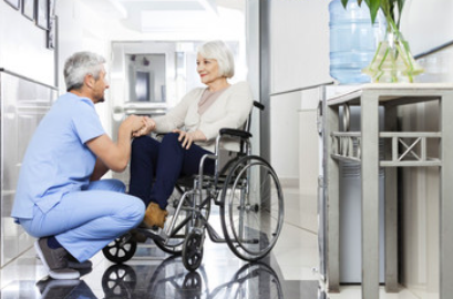 elderly woman in wheelchair talking to doctor