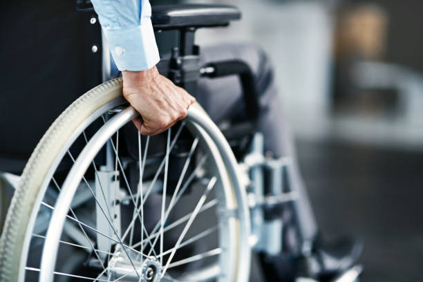 Closeup shot of a man sitting in a wheelchair