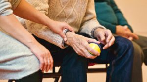 Elderly man holding a stress ball in a nursing home - Elder Abuse Lawyer