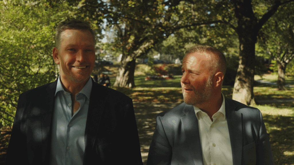 lawyers mike and phil walking through greenery