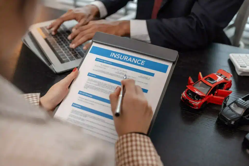 a lawyer explains the details of a car insurance policy and all the costs to a client