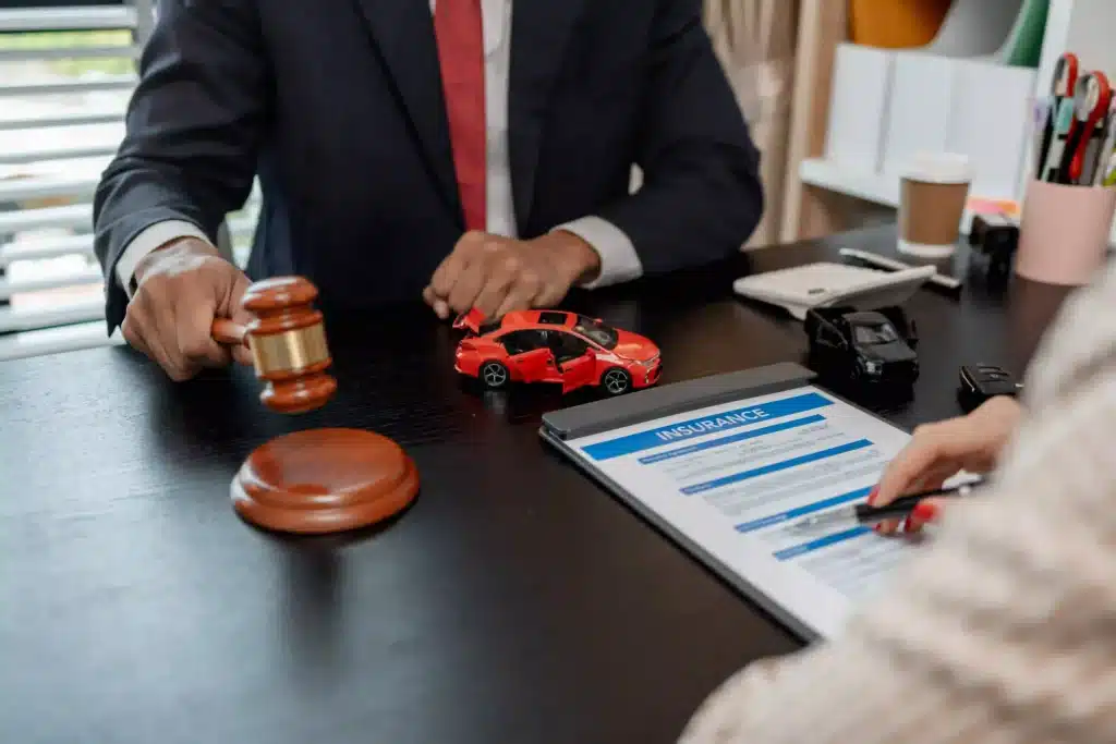 Lawyer with a gavel explaining car insurance