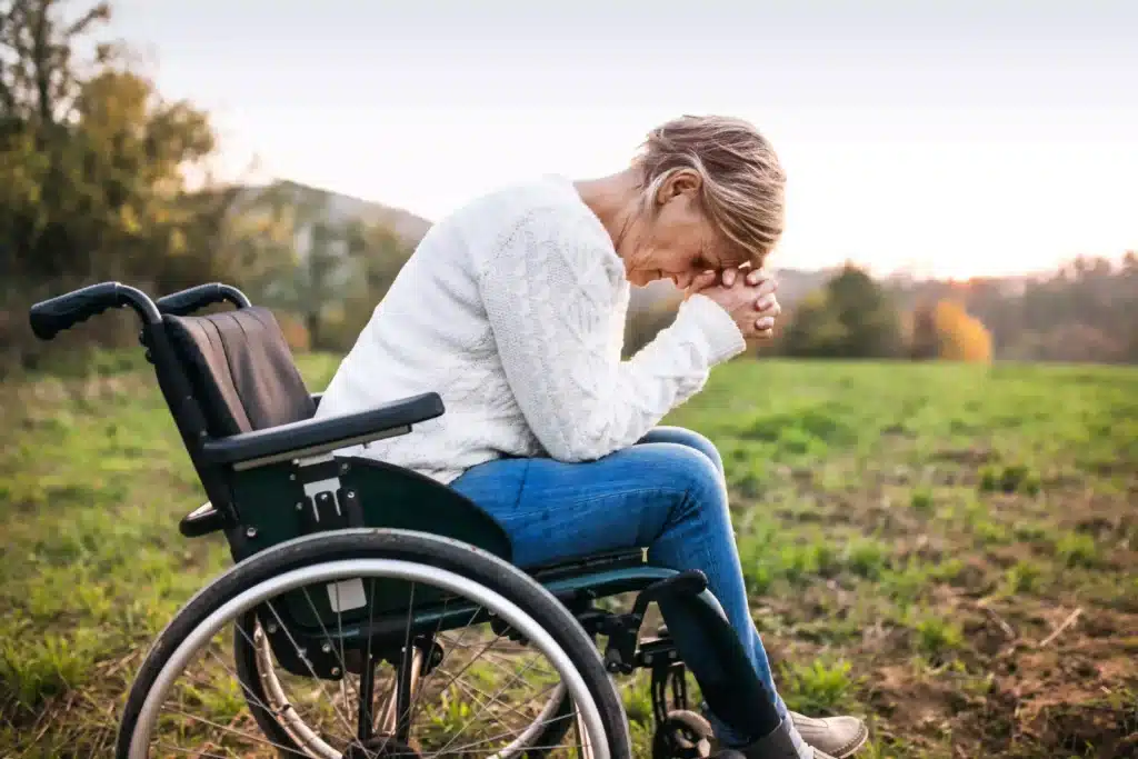 A senior woman in a wheelchair in nature