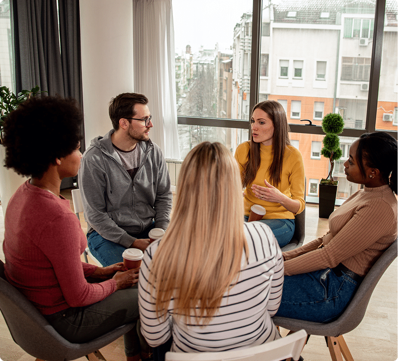 group of diverse people speaking sitting in a circle