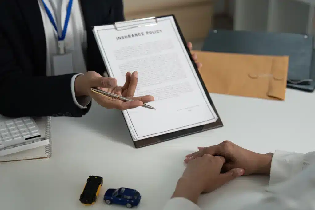 Insurance Consultation. Client discussing policy details with agent in office.