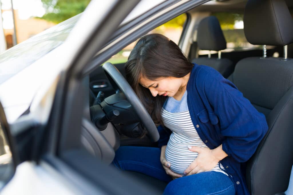 Pregnant woman in pain after a car accident