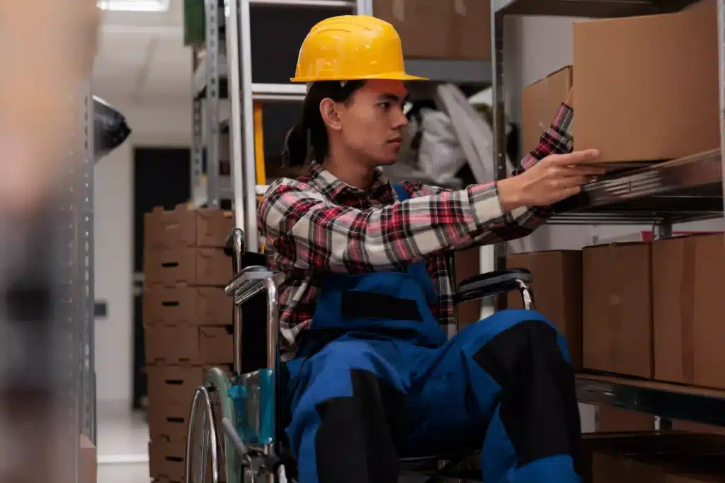 "Storehouse employee in wheelchair taking box for order packing "