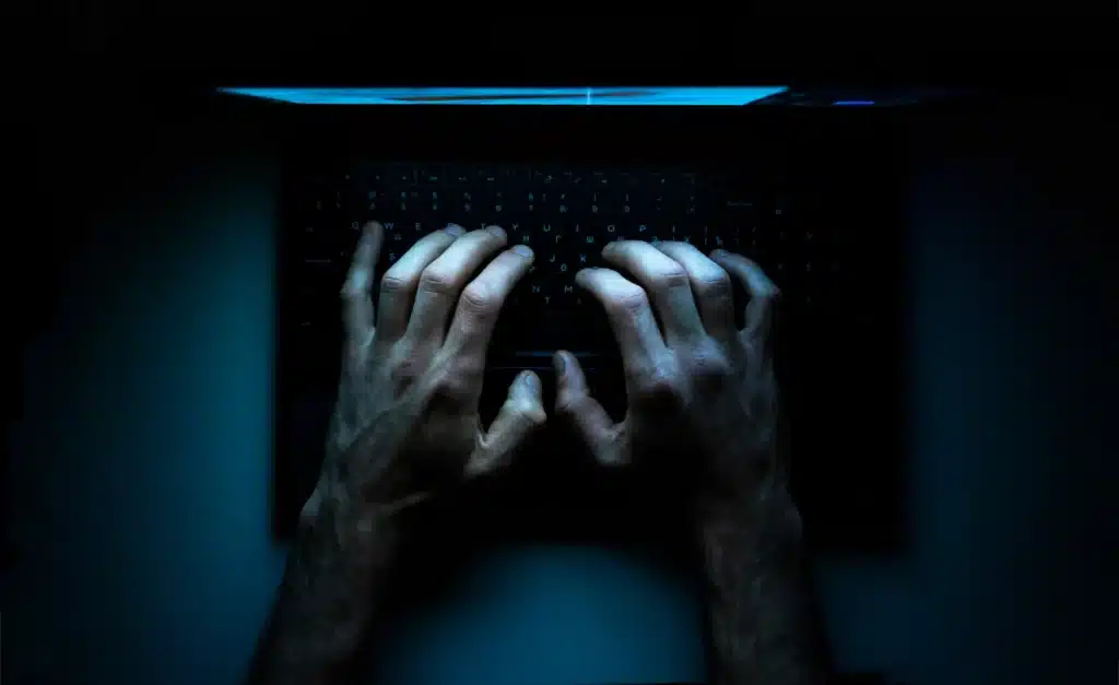 Top view of hands typing on a laptop