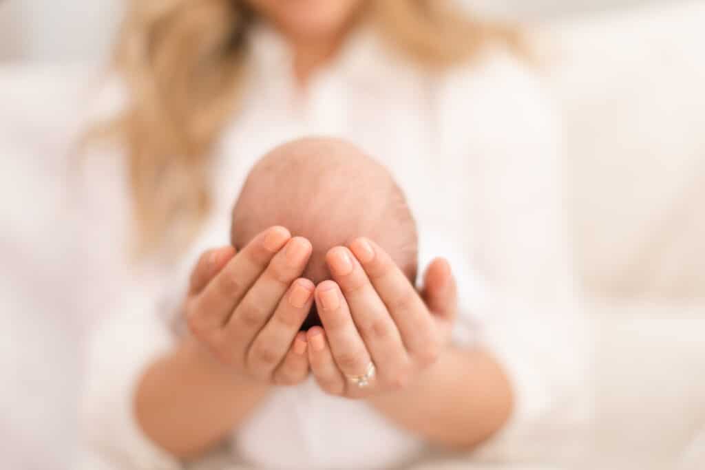mother holding newborn in her hands