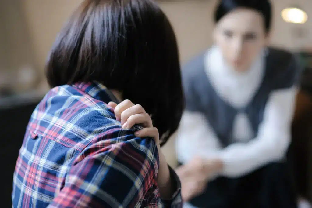 woman seeking help at counselling session indoors
