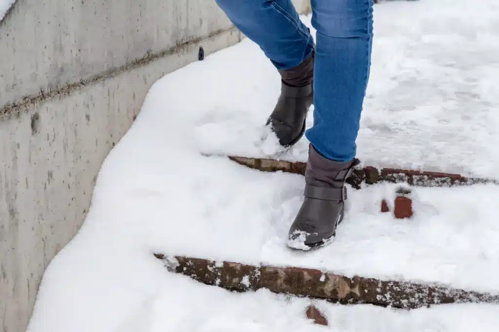 Woman Steps In Snow Winter Walking Down The Stairs